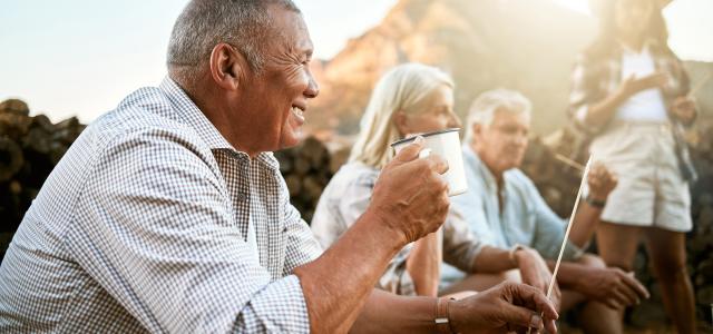 Relaxed senior camping with friends